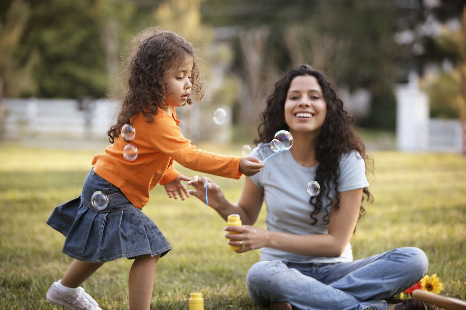 Mother and daughter playing with bubbles